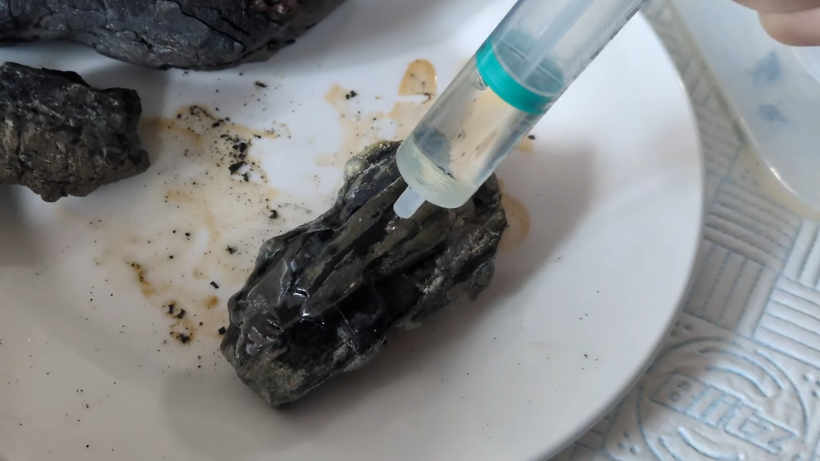 Application of the mixture with a syringe onto a specimen